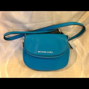 Blue leather crossbody Michael Kors purse.